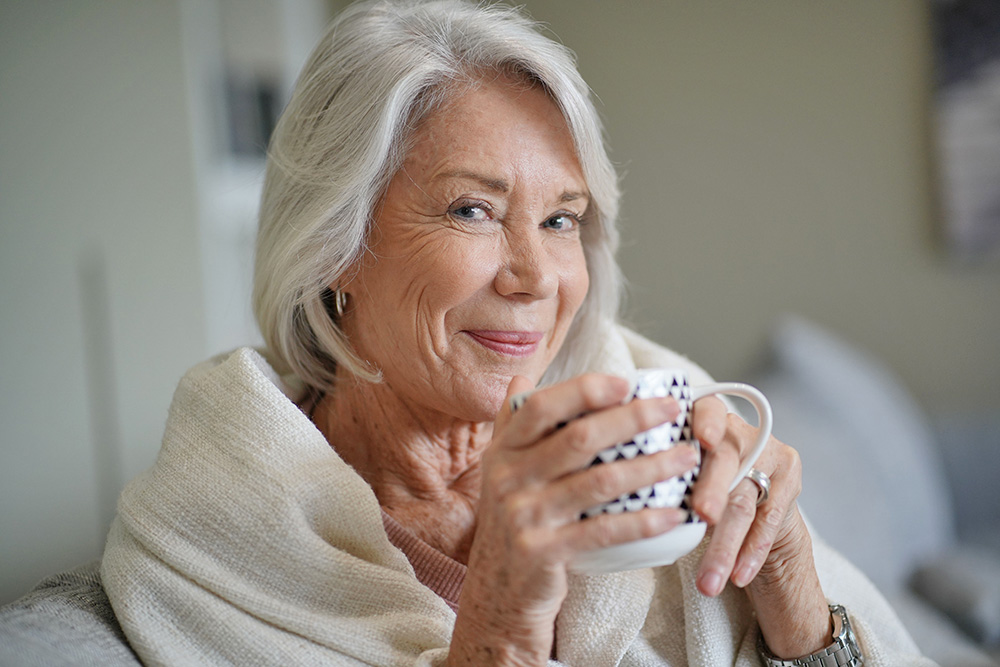 cosy,looking,senior,woman,at,home,with,hot,drink