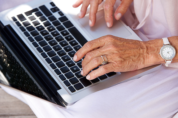 close,up,portrait,of,older,woman,typing,on,laptop,computer