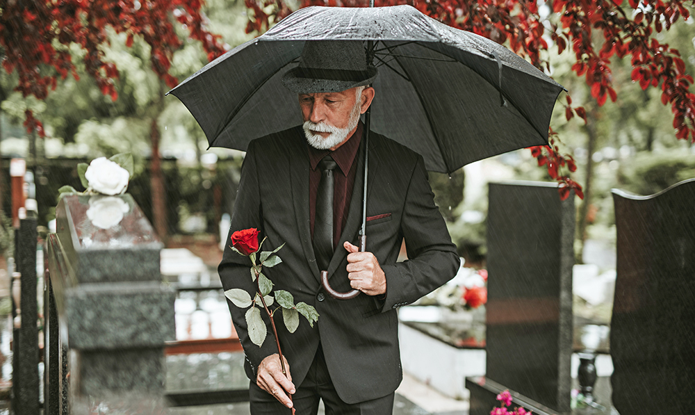 elegant,sad,elderly,man,standing,on,the,rain,with,umbrella