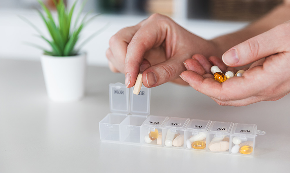 female,elderly,hands,sorting,pills.,closeup,of,medical,pill,box
