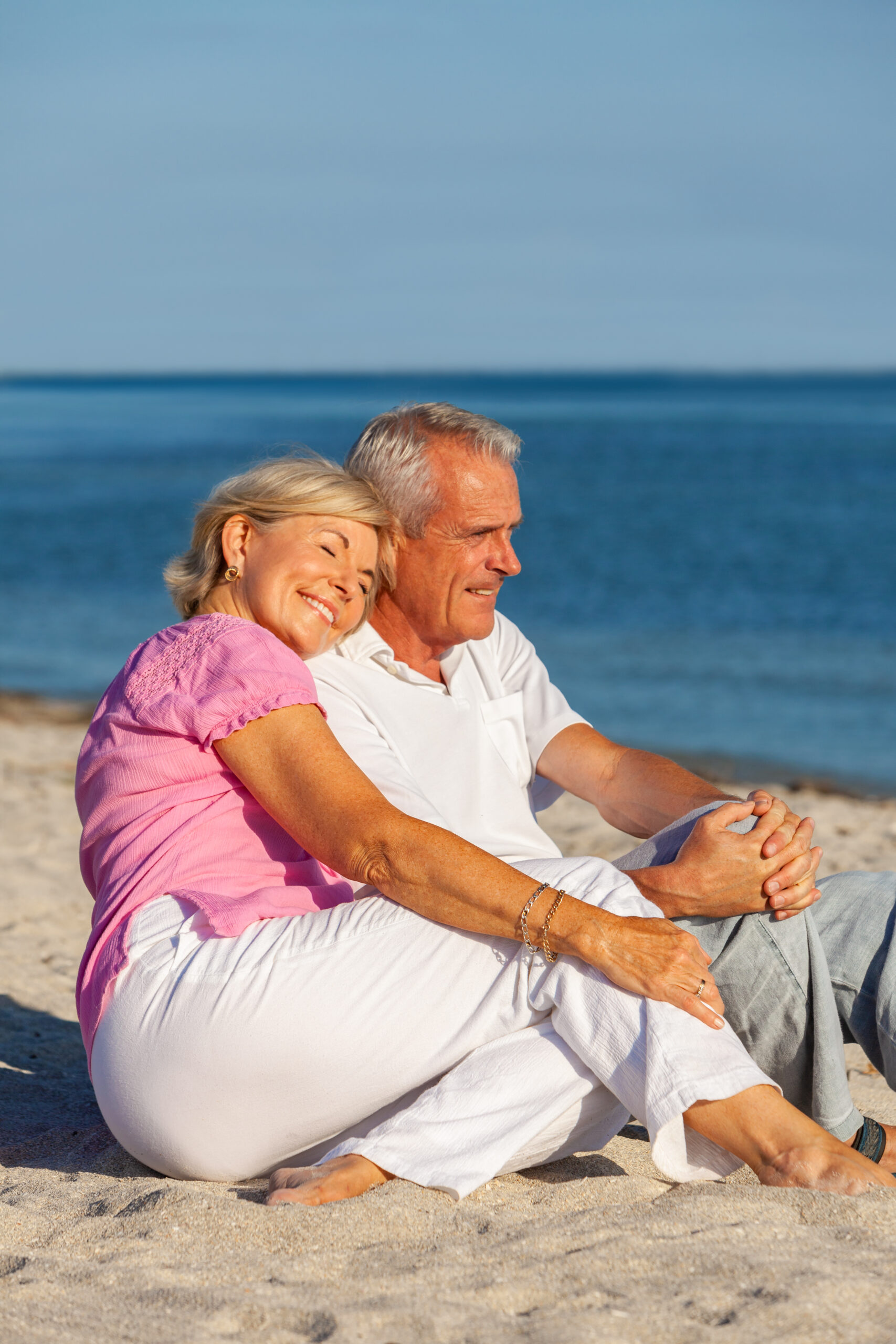 happy,senior,man,and,woman,couple,sitting,together,on,a