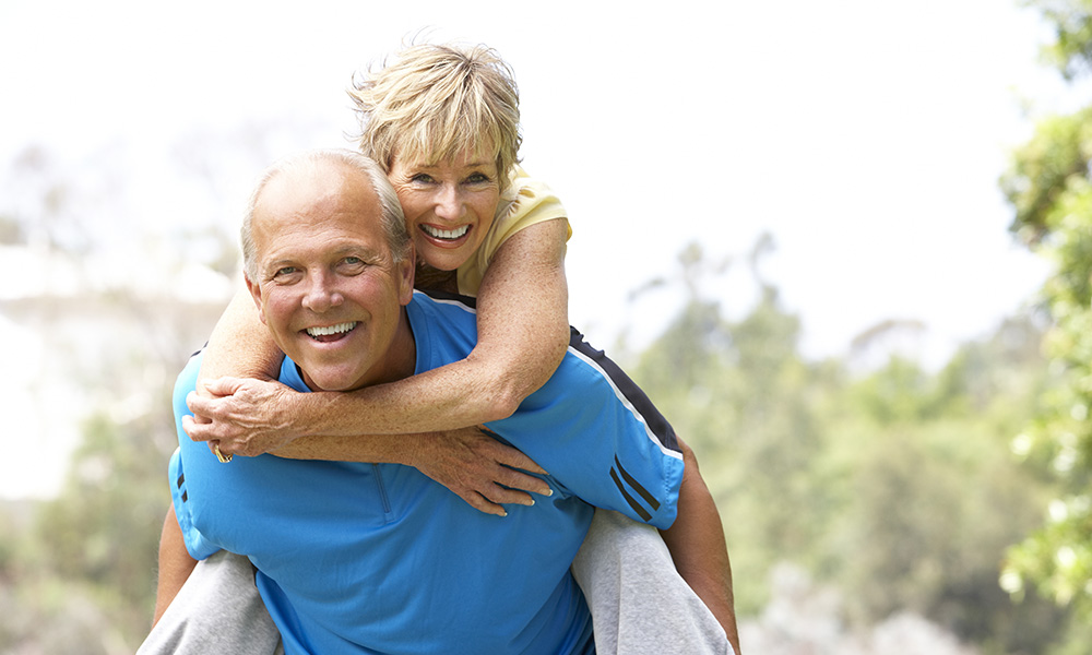 senior,couple,exercising,in,park