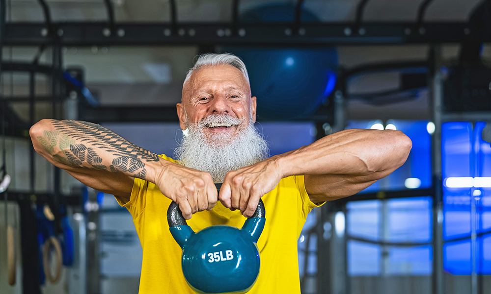 senior,fitness,man,doing,kettle,bell,exercises,inside,gym,