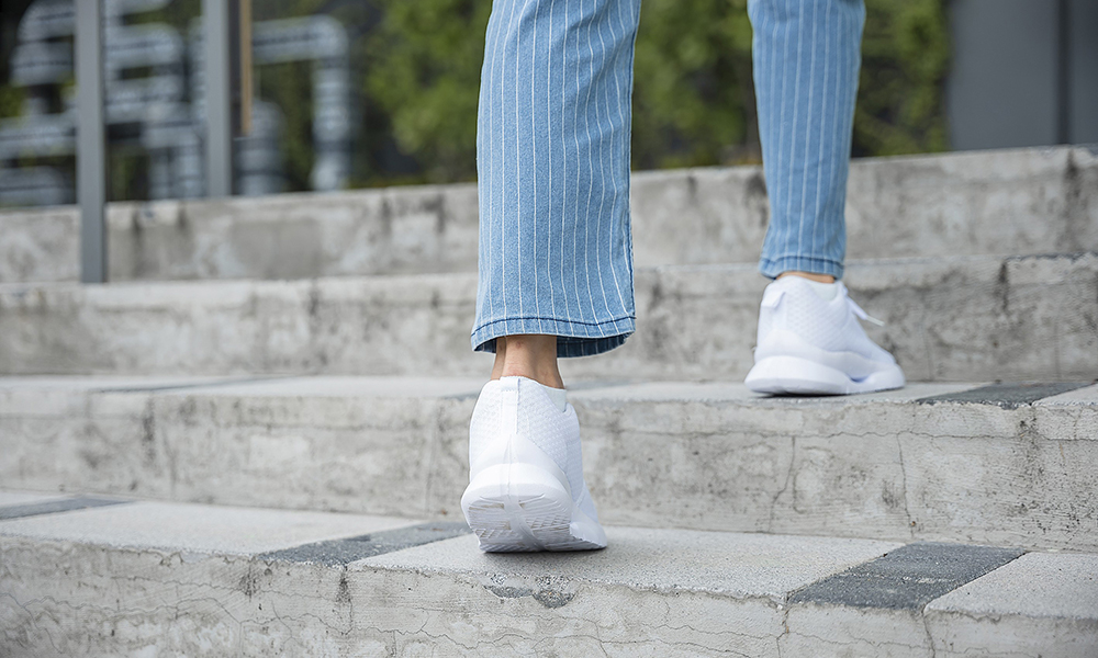 a,businesswoman,in,sneakers,conquers,the,city,stairs,,symbolizing,her