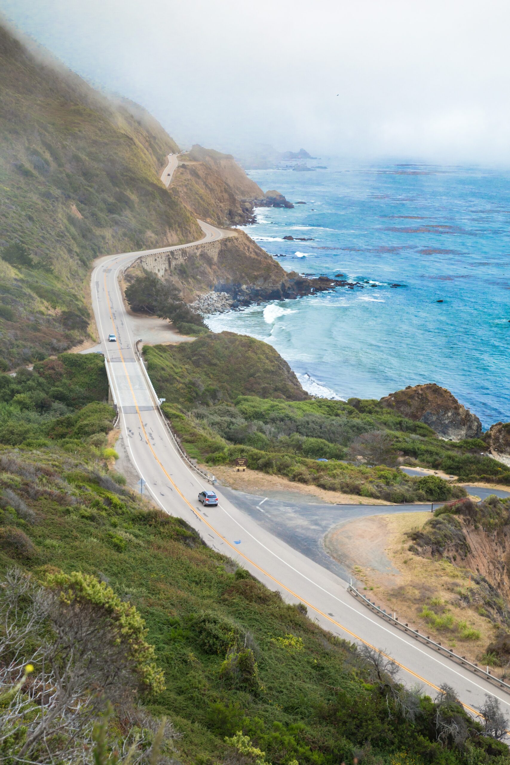 overlook,of,highway,1,with,fog,by,the,pacific,ocean