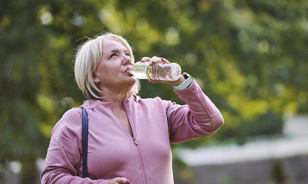 an,elderly,woman,drinks,water,after,a,hard,workout,in