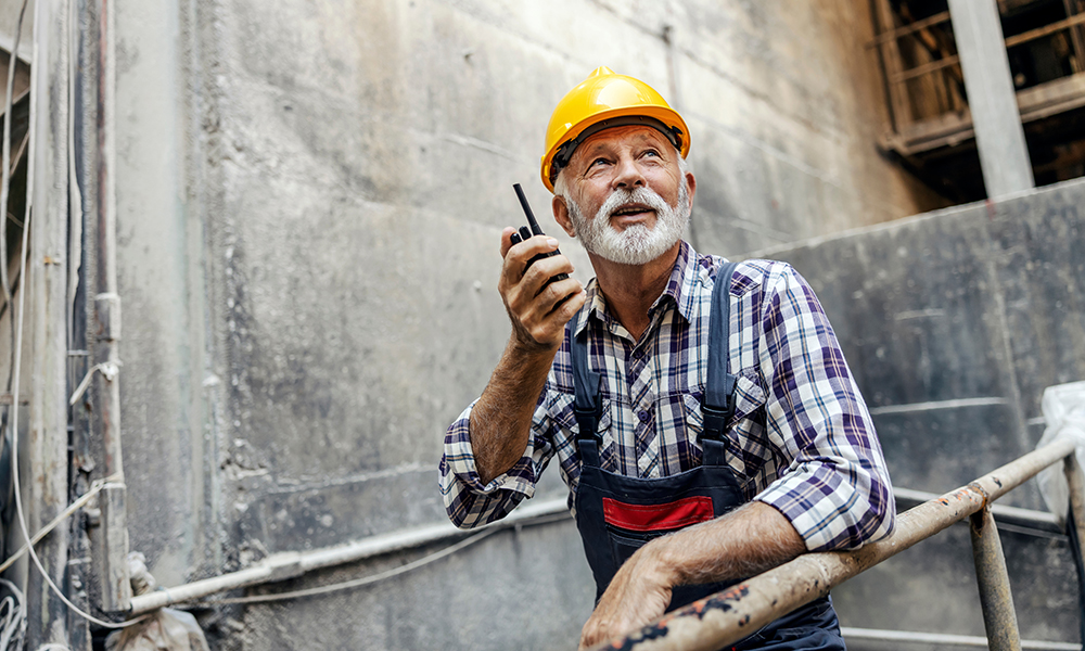 an,old,factory,worker,with,a,helmet,on,his,head,