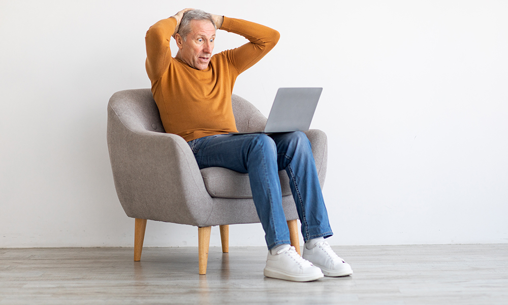 omg,,error.,portrait,of,shocked,mature,man,sitting,on,armchair