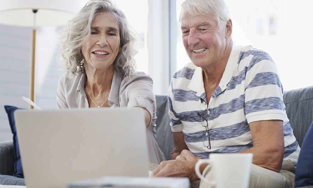 happy,,old,couple,and,laptop,on,sofa,for,budget,,financial