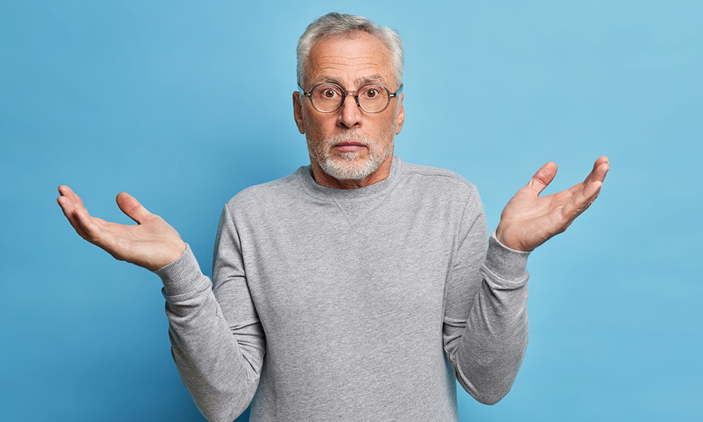 questioned,puzzled,grey,haired,man,spreads,hands,in,clueless,gesture