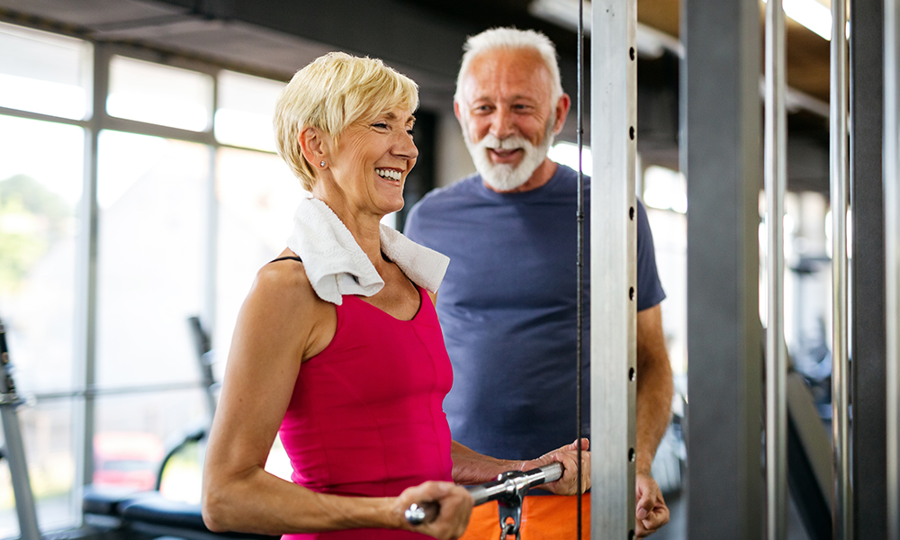 senior,fit,man,and,woman,doing,exercises,in,gym,to