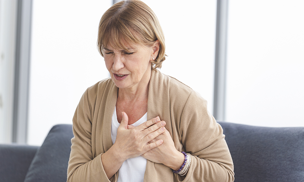 woman,with,pain,on,heart,,mature,female,presses,hand,to