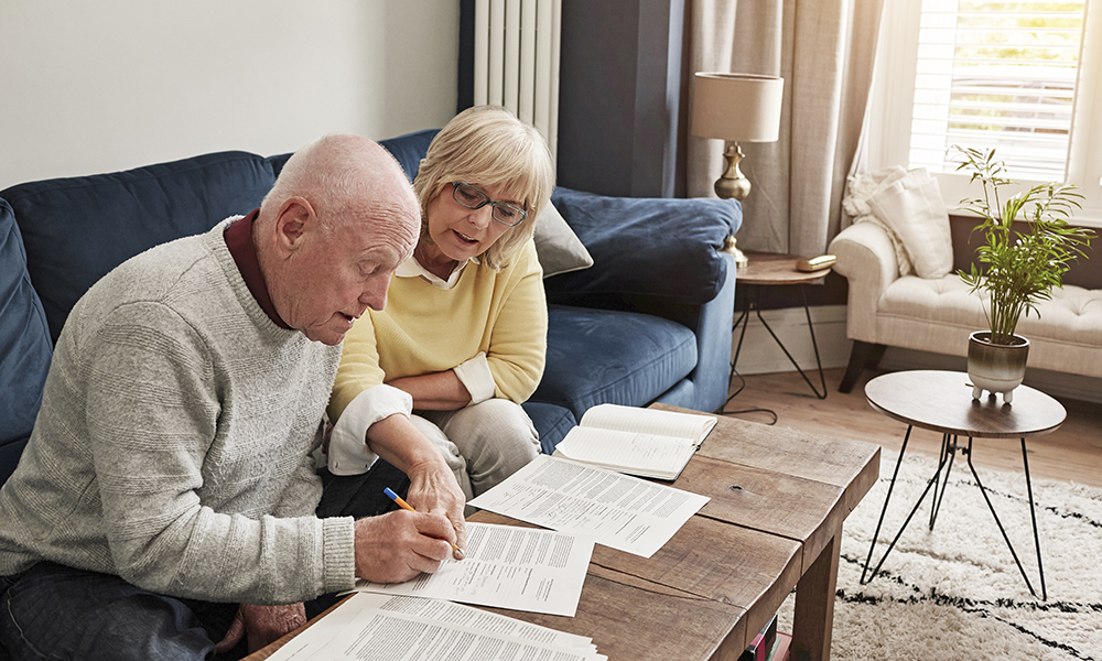 couple,,retirement,and,writing,documents,in,home,for,planning,budget,