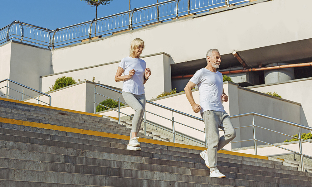 sporty,elderly,couple,running,down,the,stairs