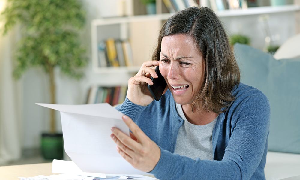 sad,adult,woman,crying,calling,on,smart,phone,with,letter