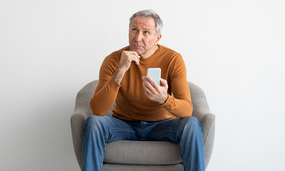 people,and,technology,concept.,portrait,of,pensive,mature,man,using