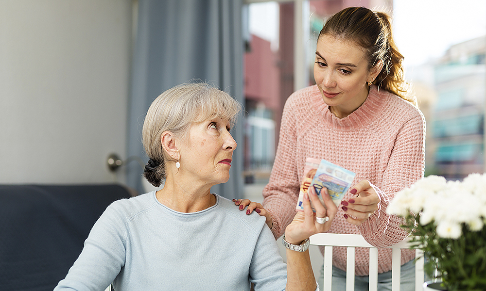 dissatisfied,elderly,woman,sitting,at,home,table,,counting,family,budget