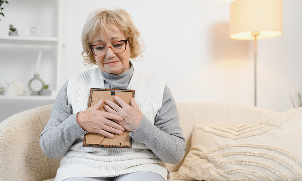 sad,old,elderly,with,depression,looks,at,photograph,of,her