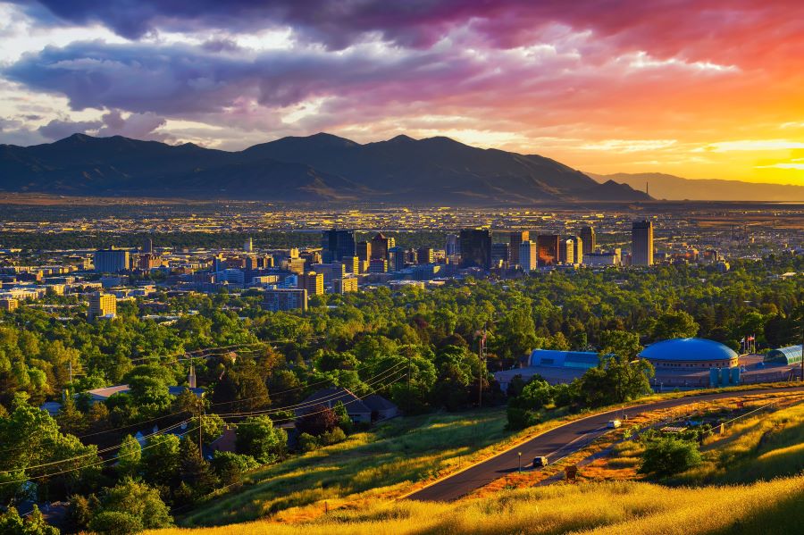 salt lake city skyline at sunset with wasatch mountains in the background