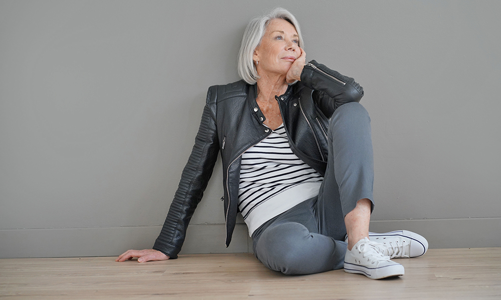 modern,senior,woman,sitting,indoors,with,leather,jacket