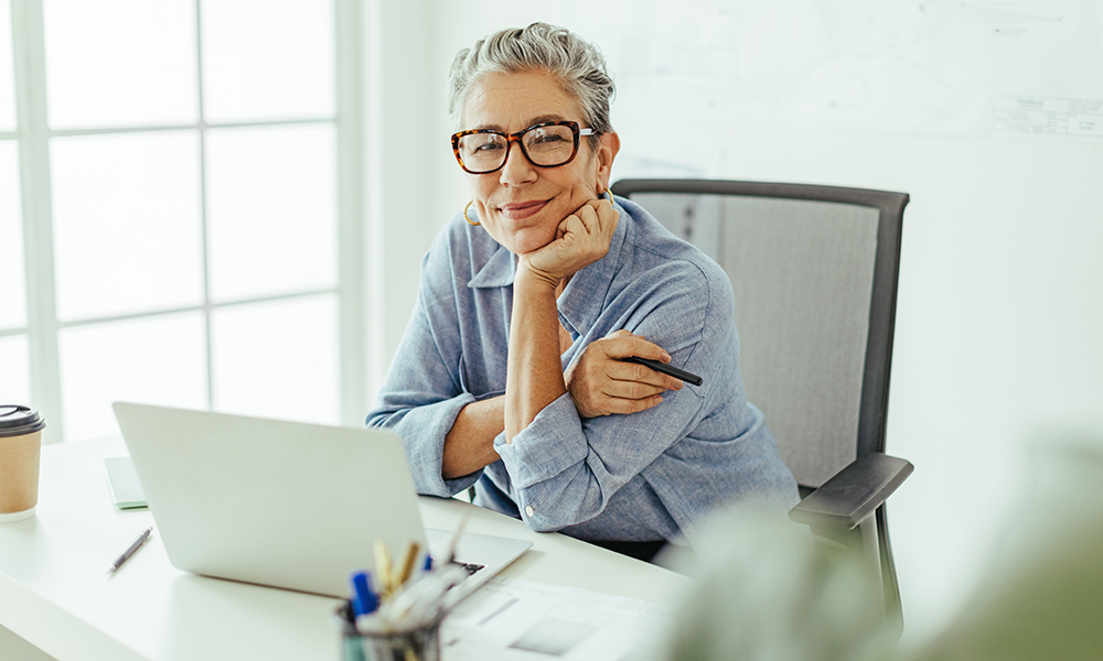 senior,graphic,designer,looking,at,the,camera,with,a,stylus