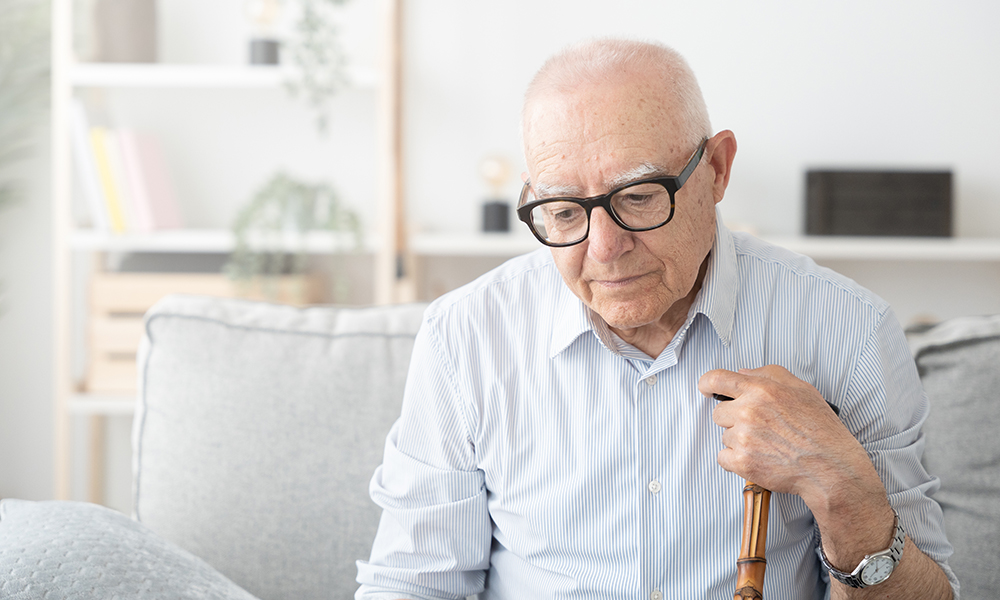 sad,elderly,man,sitting,on,sofa.,depression,and,loneliness,concept