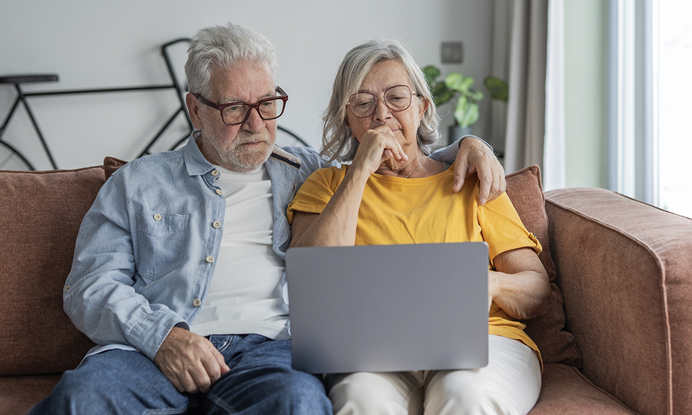 older,couple,sits,close,on,a,comfortable,sofa,,sharing,a