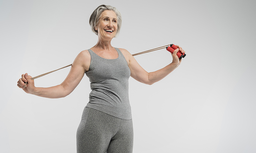 cheerful,senior,woman,with,grey,hair,holding,skipping,rope,isolated
