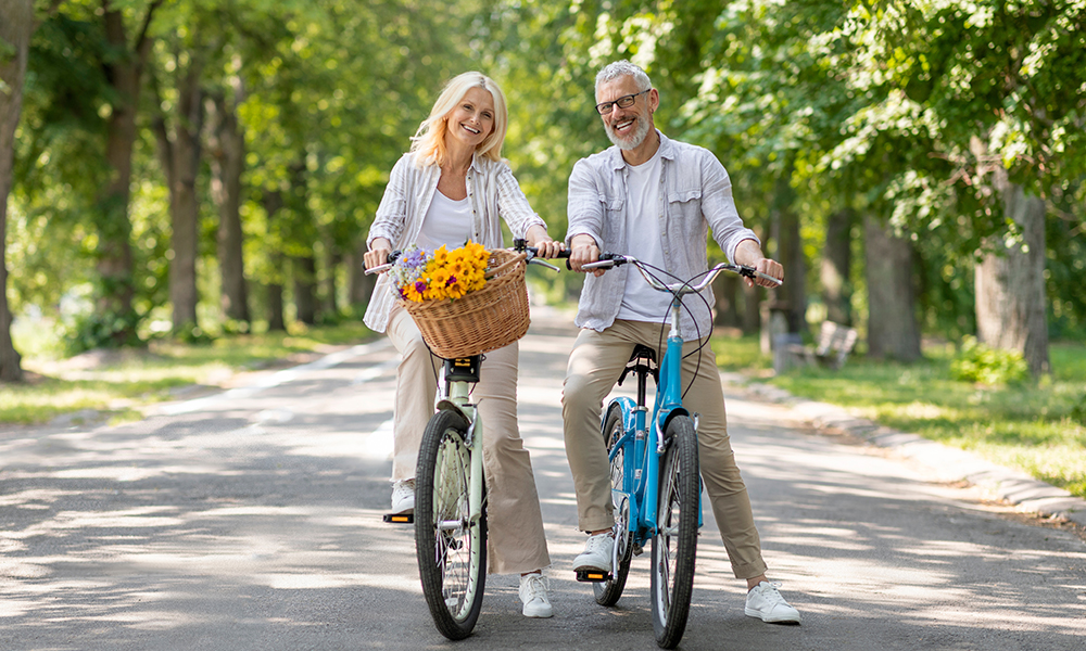 happy,senior,couple,enjoying,cycle,ride,in,summer,park,,cheerful