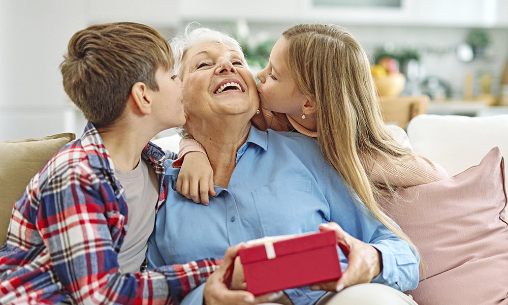 granddaughter,and,grandson,surprises,her,grandmother,with,present,on,mother's
