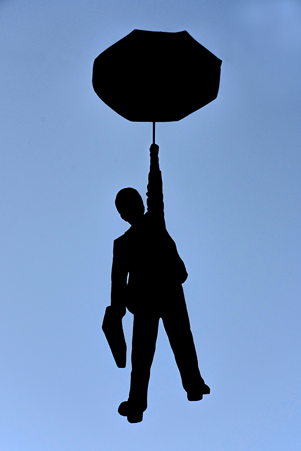 dark,silhouette,of,a,man,with,umbrella,and,bag.
