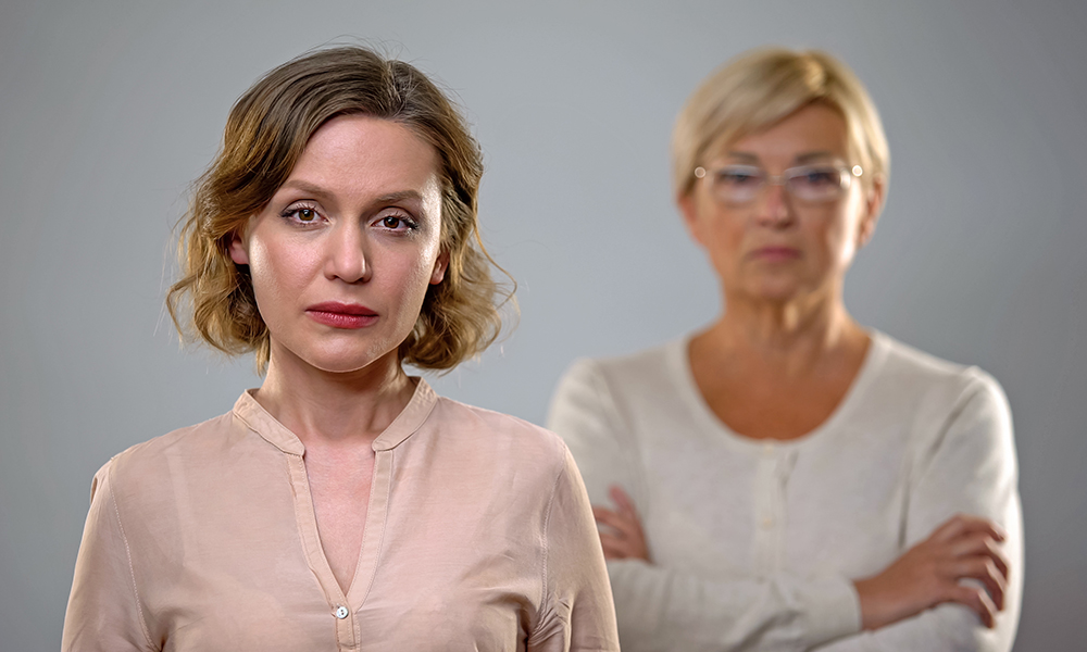 sad,young,woman,looking,in,camera,,strict,senior,mother,standing