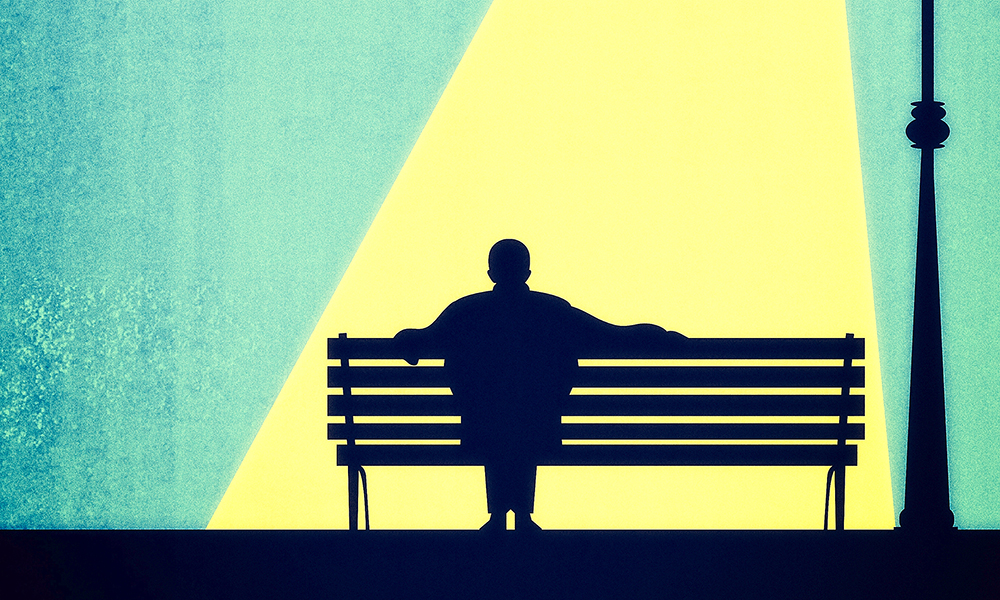 a,man,silhouette,sitting,on,a,bench,seen,from,behind