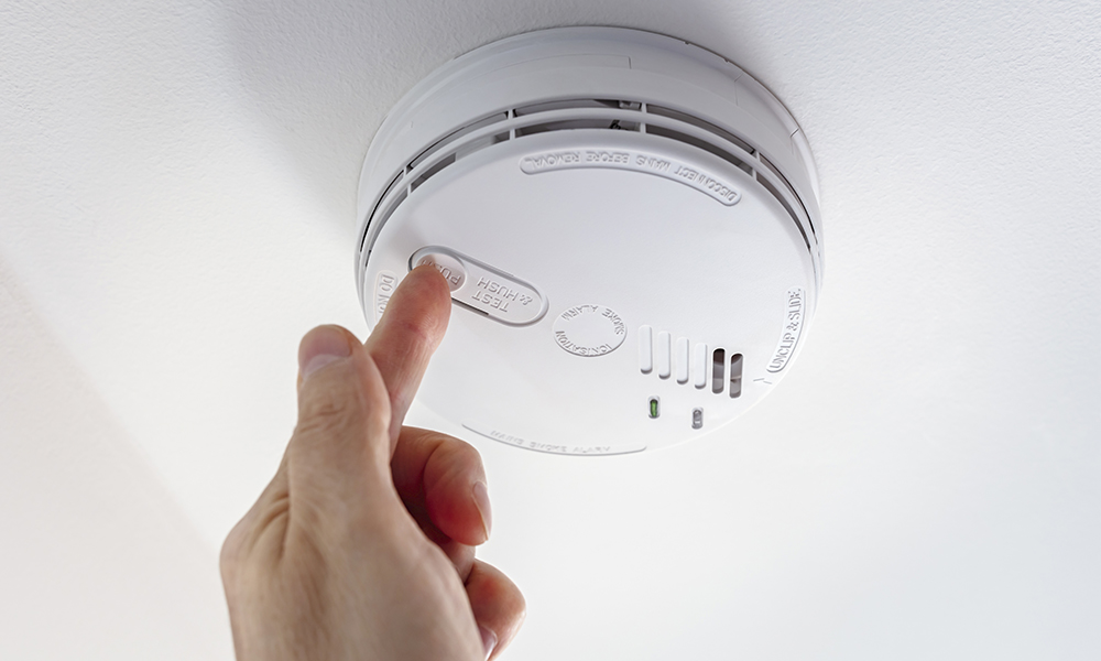 home,smoke,and,fire,alarm,detector,maintenance,man,pushing,button