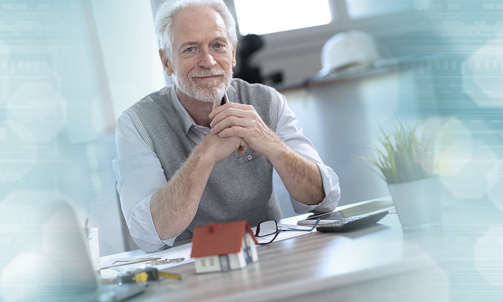 portrait,of,senior,architect,sitting,in,office,and,looking,at