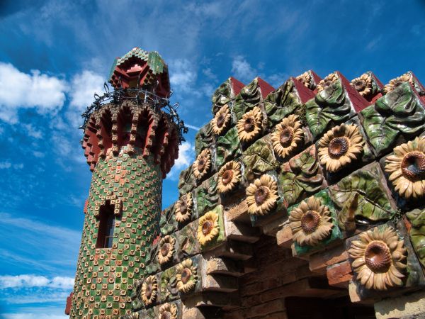 gaudi's capricho tower and archway against blue sky