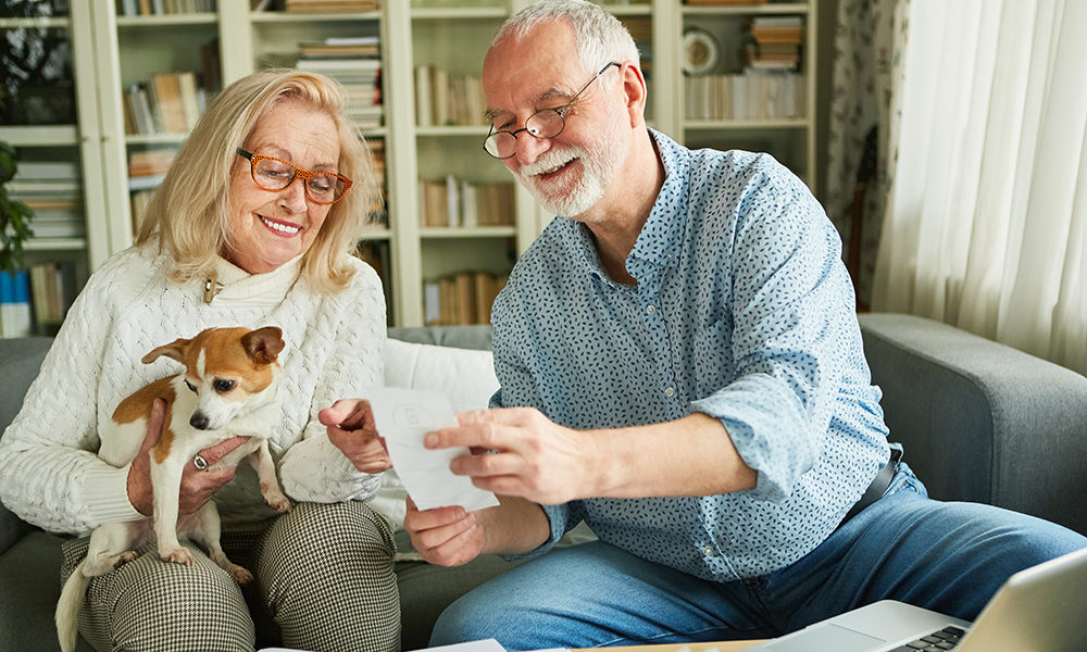 happy,senior,couple,sorting,receipts,in,bookkeeping,for,tax,return