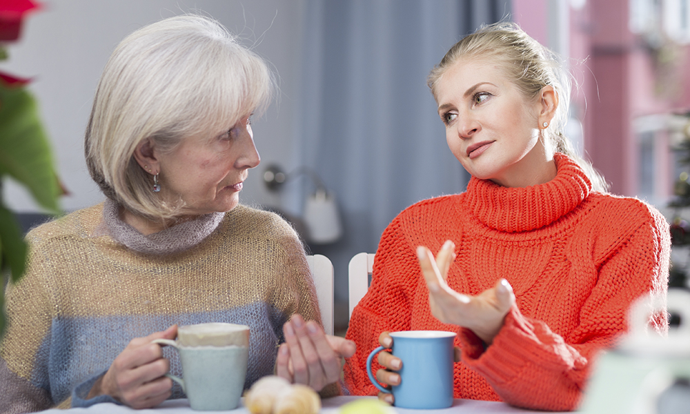 two,women,drink,tea,and,eat,cakes,near,the,new