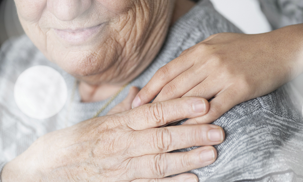 elderly,holding,a,hand,on,the,shoulder.,senior,woman,with